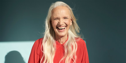 woman laughing on blue background