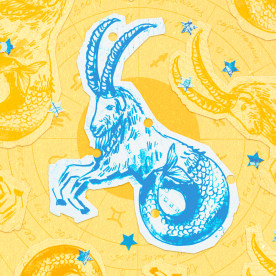Paper cutouts of the Capricorn zodiac on a yellow background