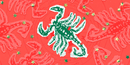 Paper cutouts of the Scorpio zodiac on a red background