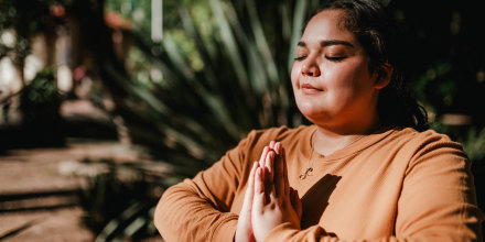 Woman meditating in park